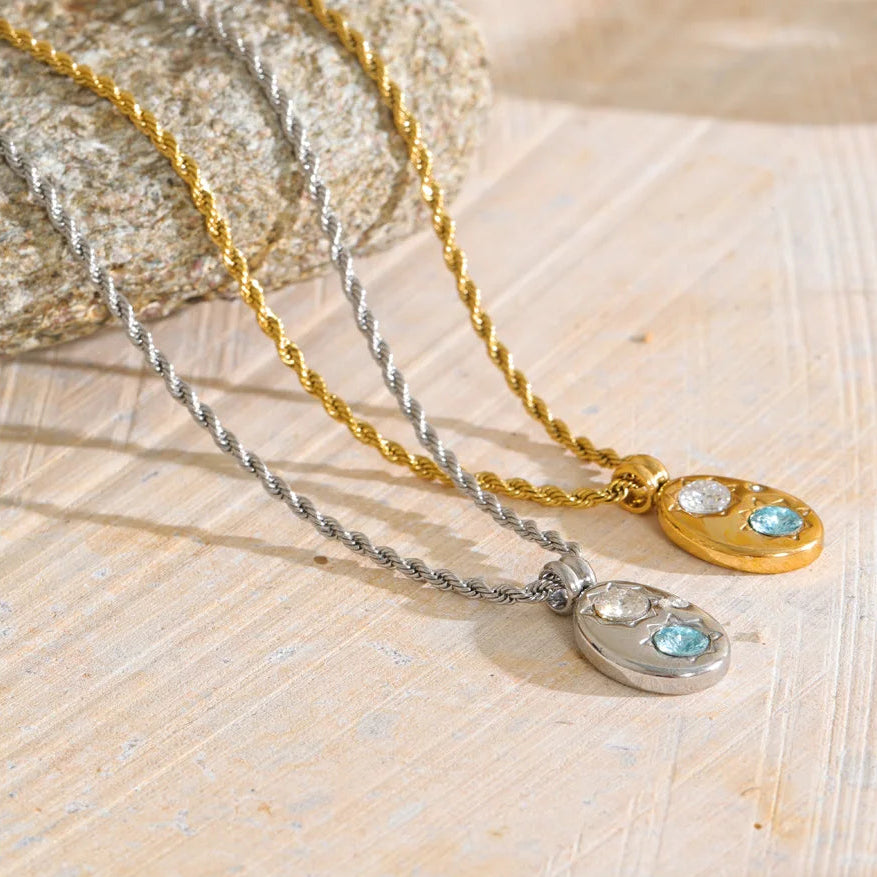 The Alba Necklace: aqua zircon, starburst details, twisted rope chain. Silver or gold. Tarnish-free, everyday.
