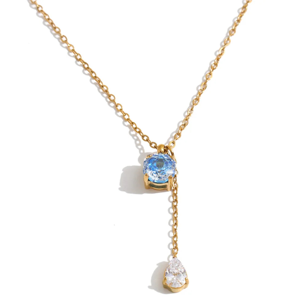 Shop the Astrid Necklace: delicate lariat with blue and clear zircons. Waterproof, hypoallergenic stainless steel in silver or 18k gold.