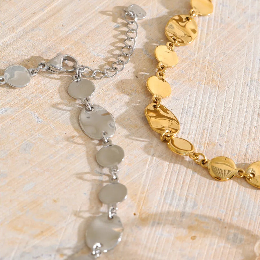 Shop the Jessica Necklace: bold organic disc necklace with a wavy, light-catching finish. Waterproof stainless steel, adjustable fit.