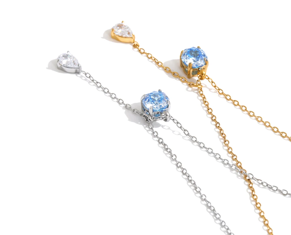 The Astrid Necklace: a blue zircon, a falling teardrop, a fine chain. Silver or gold. Tarnish-free, delicate.