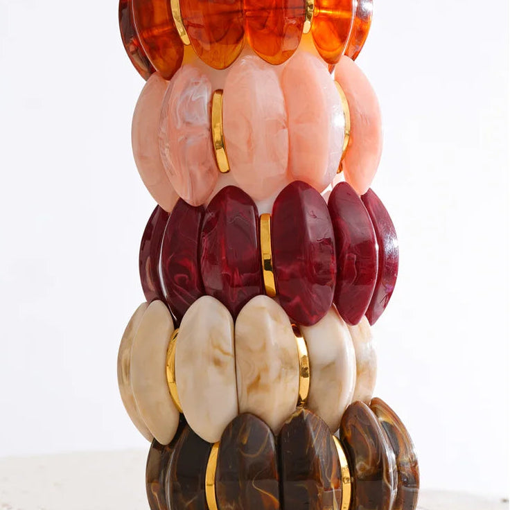 "Adalaide Bangle — chunky marbled resin beads in a sculptural wave design, finished with polished gold spacer links. A bold pop of color for stacking or wearing solo. Available in six rich marbled tones."