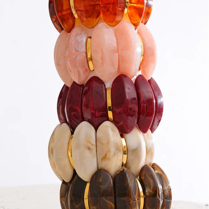 "Adalaide Bangle — chunky marbled resin beads in a sculptural wave design, finished with polished gold spacer links. A bold pop of color for stacking or wearing solo. Available in six rich marbled tones."
