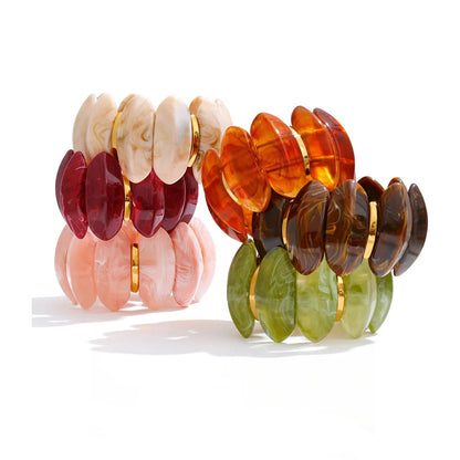 Three pairs of disc-style bracelets with gold-tone spacers, shown on a white background. The left pair features cream, burgundy, and light pink marbled discs.