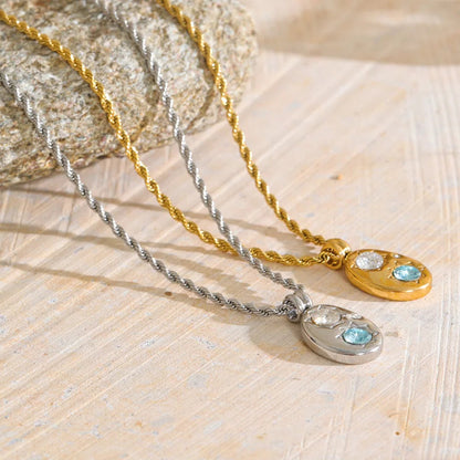 The Alba Necklace: aqua zircon, starburst details, twisted rope chain. Silver or gold. Tarnish-free, everyday.