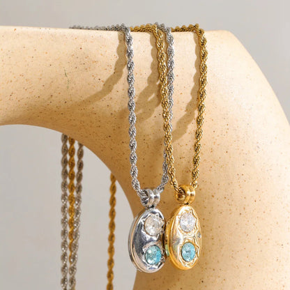 The Alba Necklace: aqua zircon, starburst details, twisted rope chain. Silver or gold. Tarnish-free, everyday.