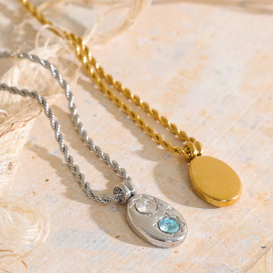 The Alba Necklace: aqua zircon, starburst details, twisted rope chain. Silver or gold. Tarnish-free, everyday.