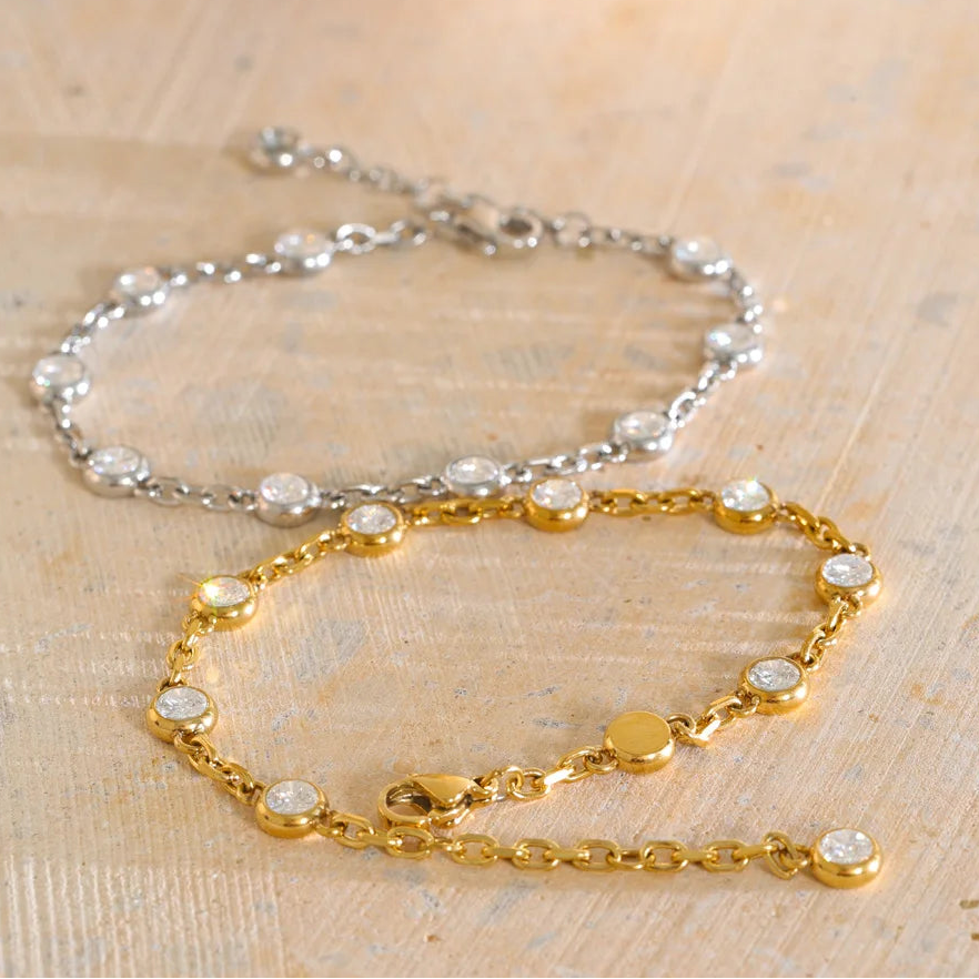 April Bracelet – dainty cable chain with bezel-set zircons. Tarnish-free stainless steel, silver or gold-tone. Adjustable, everyday sparkle.