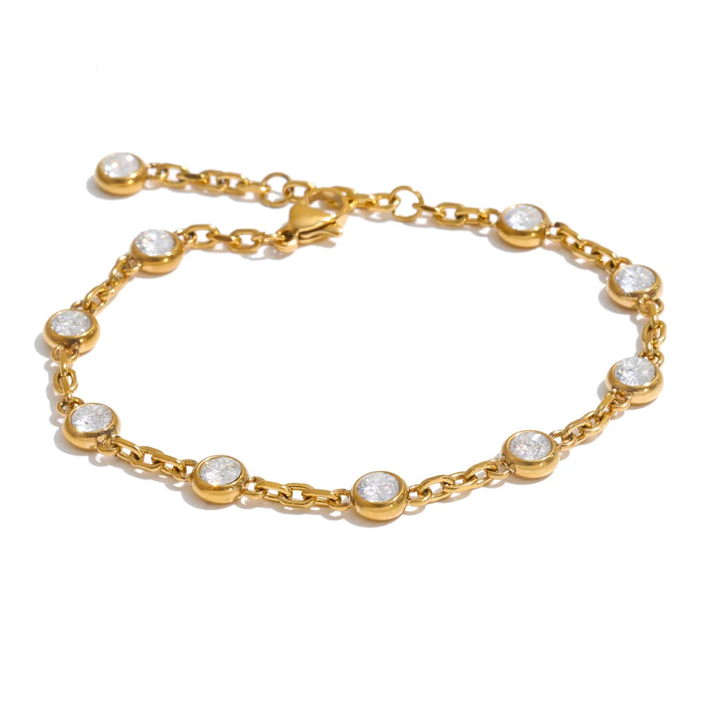 April Bracelet – dainty cable chain with bezel-set zircons. Tarnish-free stainless steel, silver or gold-tone. Adjustable, everyday sparkle.