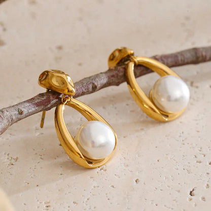 Gold earrings with pearls on a branch