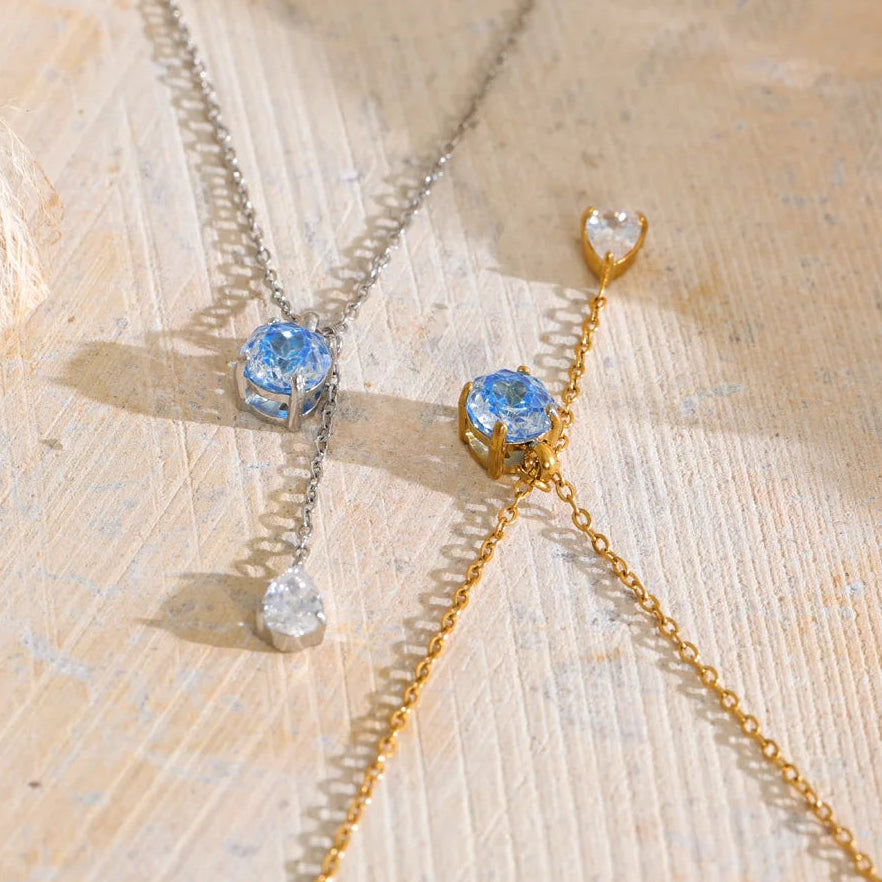 The Astrid Necklace: a blue zircon, a falling teardrop, a fine chain. Silver or gold. Tarnish-free, delicate.