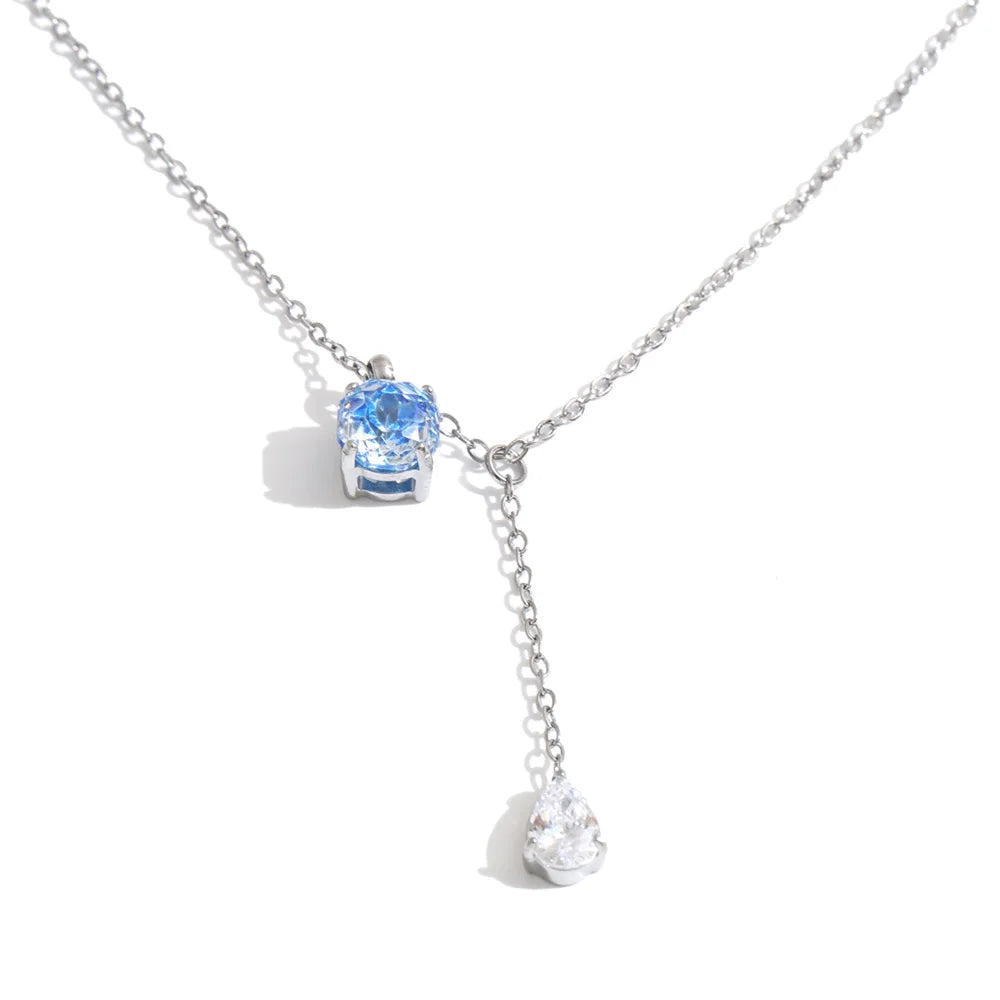 Shop the Astrid Necklace: delicate lariat with blue and clear zircons. Waterproof, hypoallergenic stainless steel in silver or 18k gold.