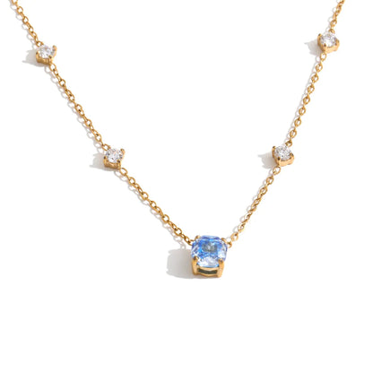 Shop the Bella Necklace: dainty gold station necklace with a blue zircon pendant. Waterproof, hypoallergenic stainless steel, adjustable.