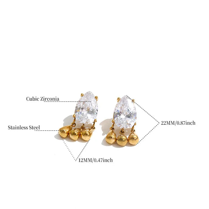 A product information graphic showing a pair of gold-toned stud earrings with large clear cubic zirconia stones and small round gold beads at the base, with measurement callouts and a small spec table below on a white background.