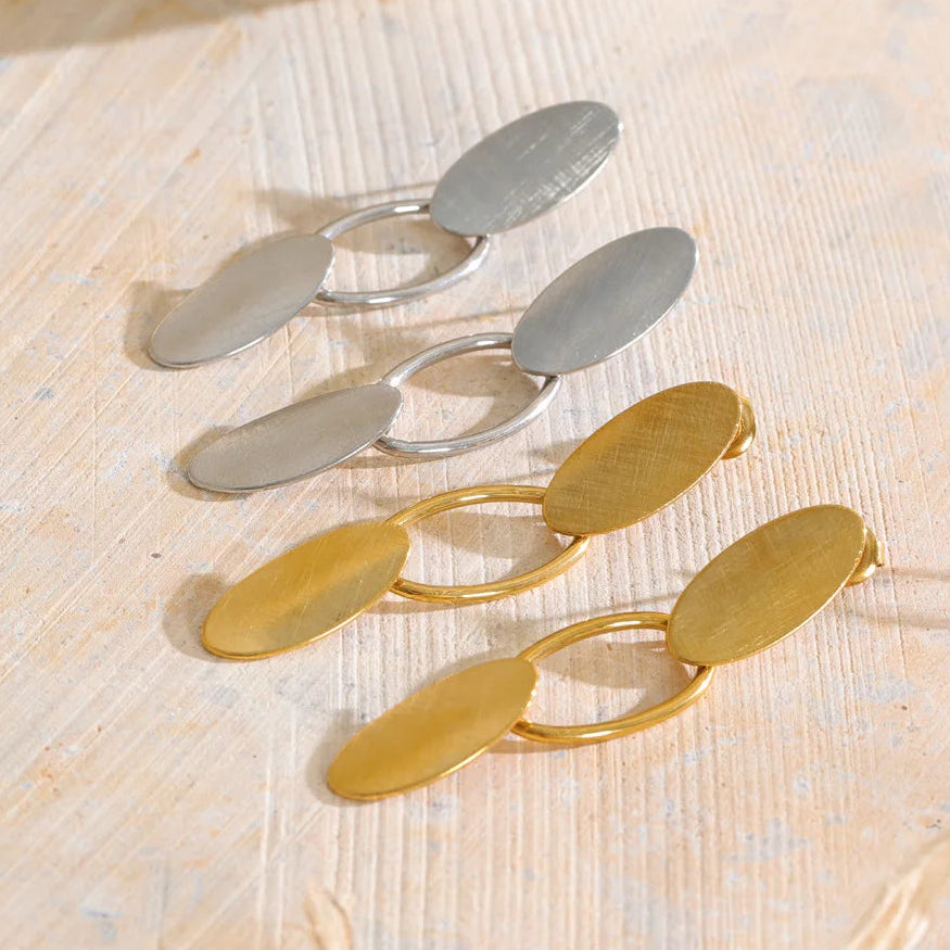 Shop the Emily Earrings: minimalist brushed-finish oval drops in silver or 18k gold-tone. Waterproof, hypoallergenic stainless steel.
