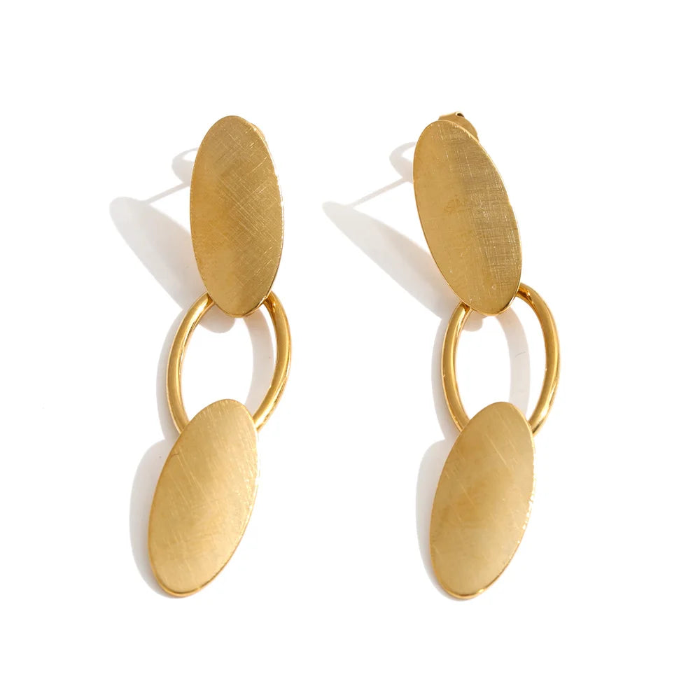 Shop the Emily Earrings: minimalist brushed-finish oval drops in silver or 18k gold-tone. Waterproof, hypoallergenic stainless steel.