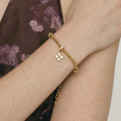Gold stainless steel waterproof charm bracelet on model.