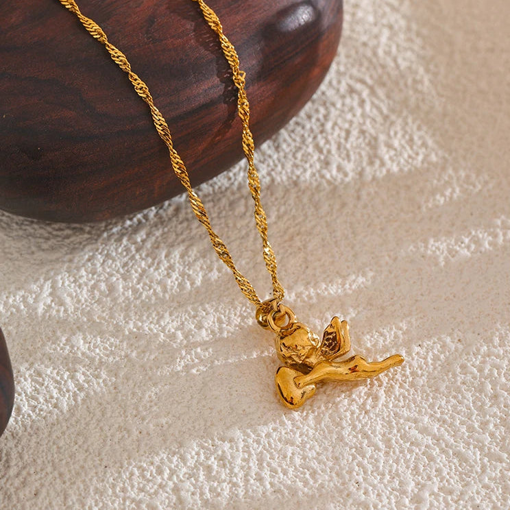 Gold necklace with a pendant on a textured surface