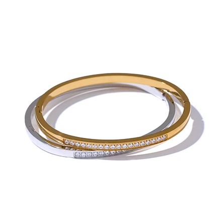 Harriet Bangle — a slim, sparkling line of pavé stones on a sleek stainless steel band. Simple enough for everyday, striking enough to stack. Available in gold or silver.