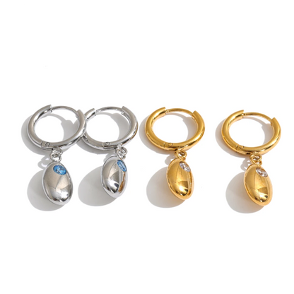 Shop the Helena Earrings: hinged huggies with a smooth oval drop and zircon accent. Waterproof stainless steel, silver or 18k gold.