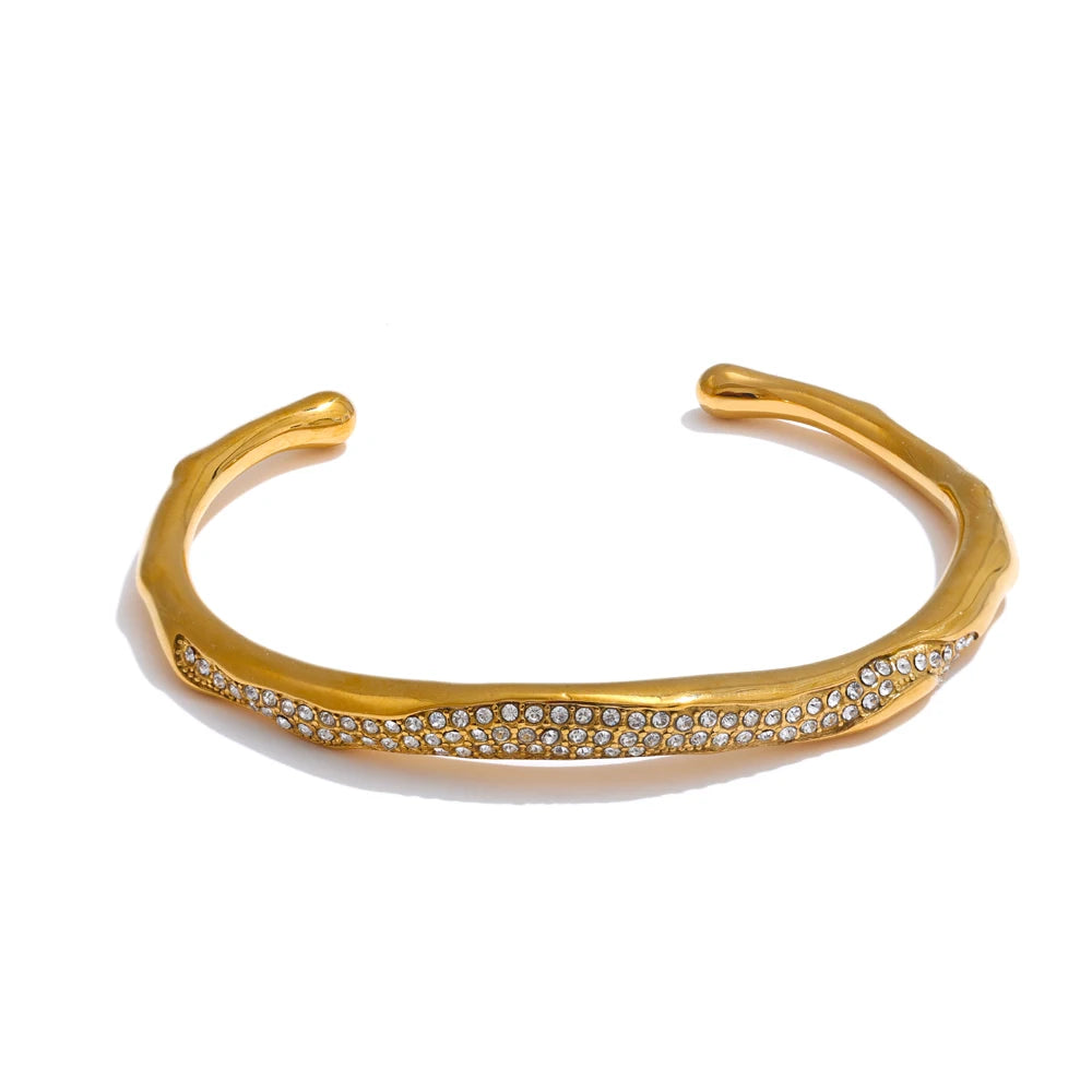Gold bracelet with small diamonds on a white background