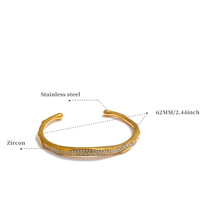 Gold bracelet with zirconia stones on a white background, showing measurements and material details.