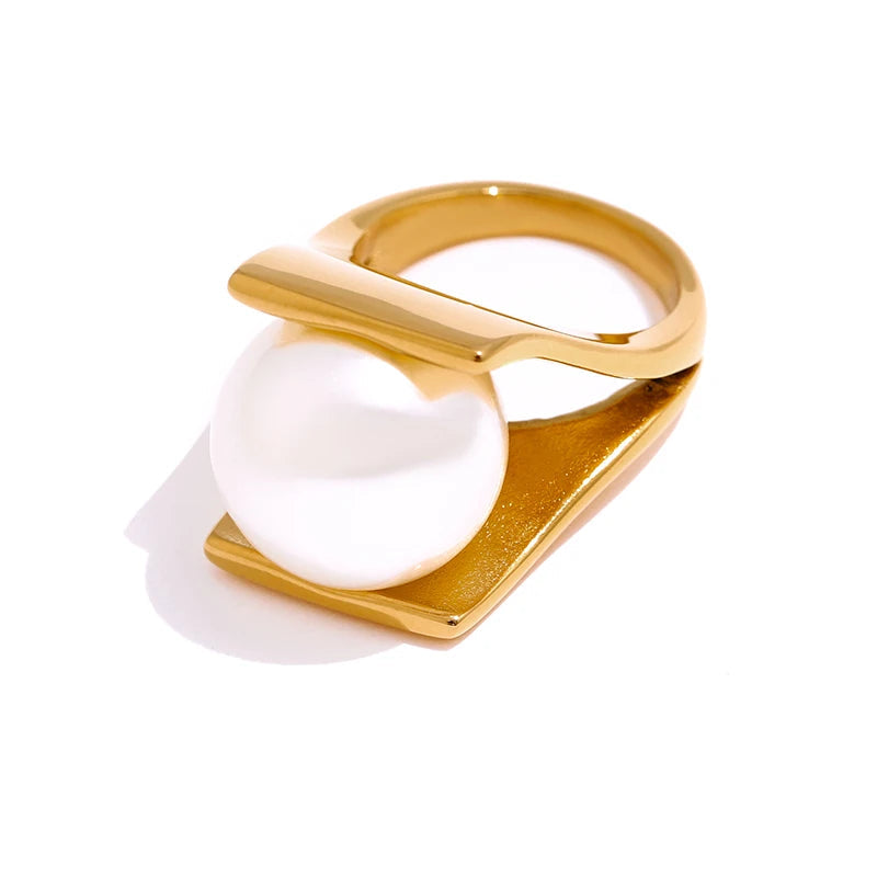 Gold ring with a white pearl on a white background, stainless steel