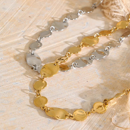Shop the Jessica Necklace: bold organic disc necklace with a wavy, light-catching finish. Waterproof stainless steel, adjustable fit.