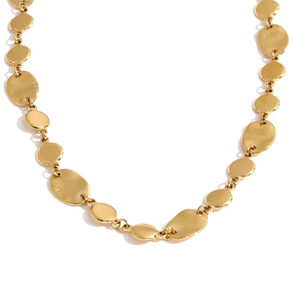 Shop the Jessica Necklace: bold organic disc necklace with a wavy, light-catching finish. Waterproof stainless steel, adjustable fit.