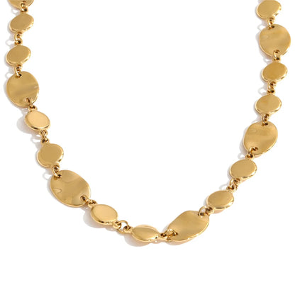 Shop the Jessica Necklace: bold organic disc necklace with a wavy, light-catching finish. Waterproof stainless steel, adjustable fit.