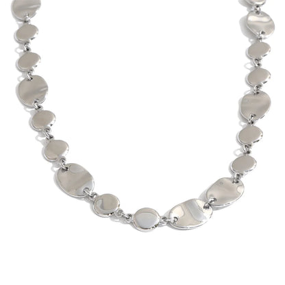 Shop the Jessica Necklace: bold organic disc necklace with a wavy, light-catching finish. Waterproof stainless steel, adjustable fit.