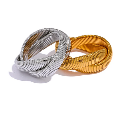 two metallic bracelets in gold and silver on a white background with text about fashion and personality.