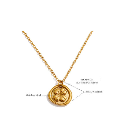 Gold necklace with a clover-shaped pendant on a white background