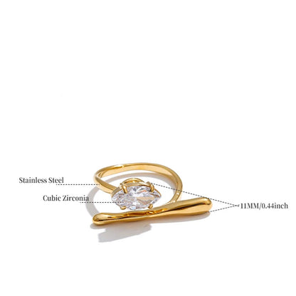 Gold ring with clear gemstone on a white background
