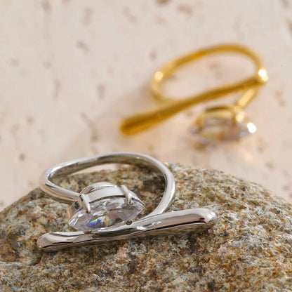 Silver ring with a diamond on a textured stone surface