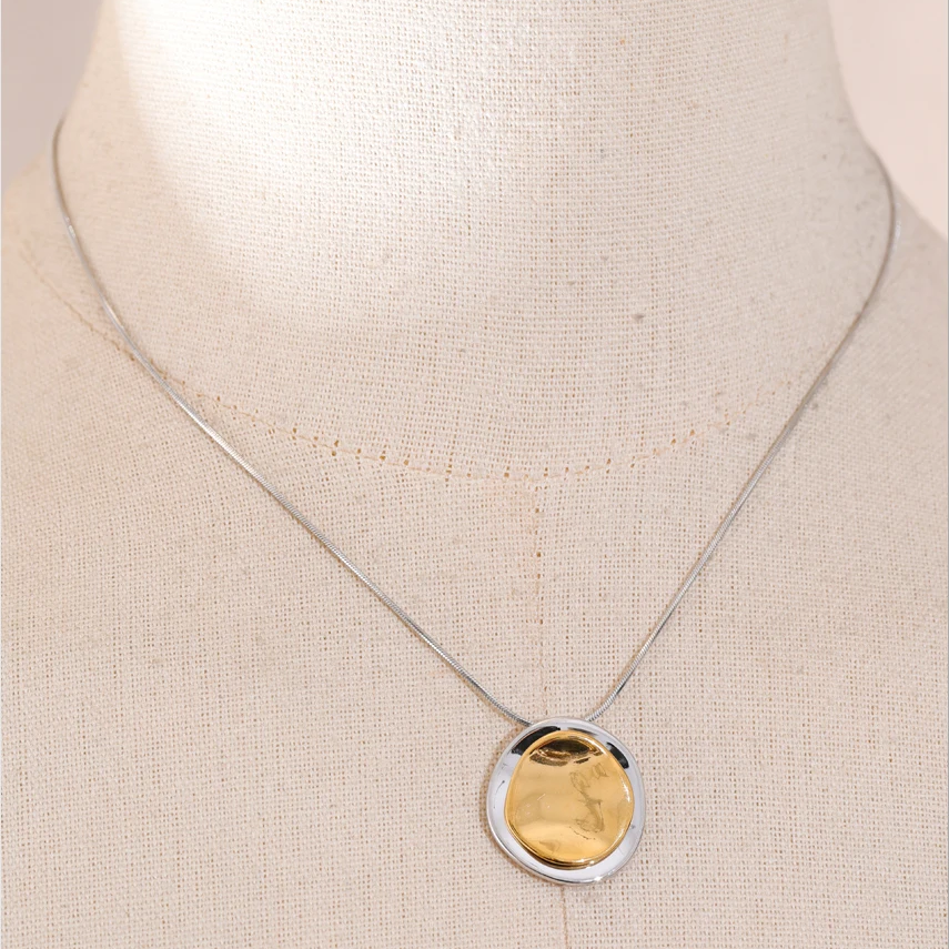 Necklace with a gold pendant on a beige background