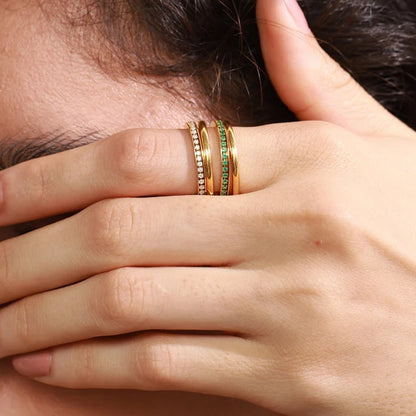 Close-up of a hand with gold rings covering part of a face