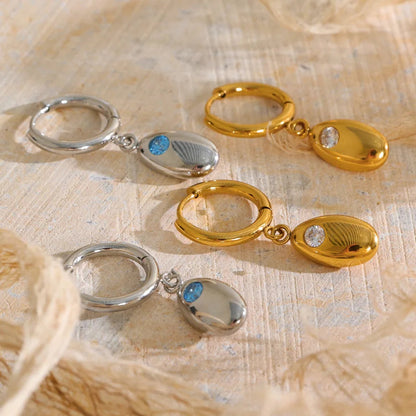 Shop the Helena Earrings: hinged huggies with a smooth oval drop and zircon accent. Waterproof stainless steel, silver or 18k gold.