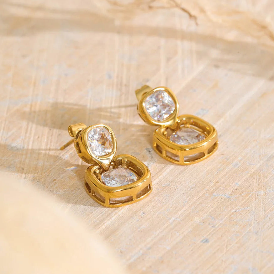 Shop the Sophie Earrings: modern drop studs with stacked cushion-cut zircons. Waterproof, hypoallergenic stainless steel in 18k gold-tone.