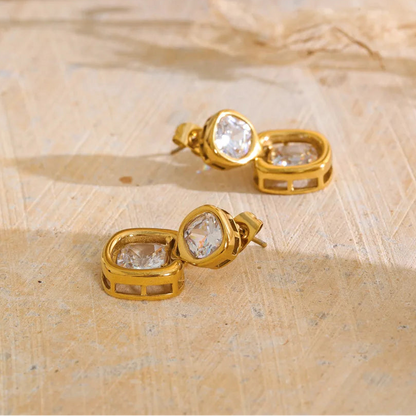 Shop the Sophie Earrings: modern drop studs with stacked cushion-cut zircons. Waterproof, hypoallergenic stainless steel in 18k gold-tone.