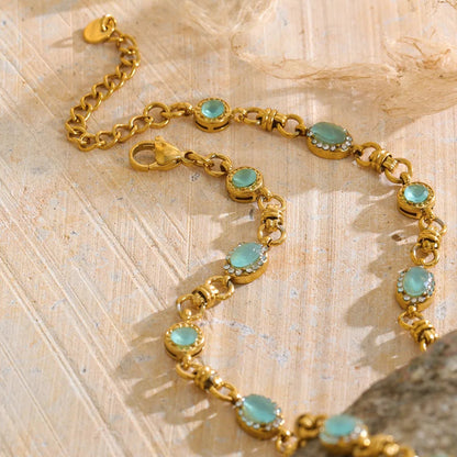 Vintage-inspired Vivienne Necklace: gold link chain with aqua-green stones and zircon halos. Tarnish-free stainless steel, adjustable fit.