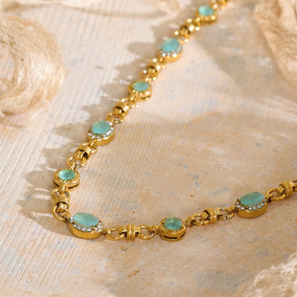 Vintage-inspired Vivienne Necklace: gold link chain with aqua-green stones and zircon halos. Tarnish-free stainless steel, adjustable fit.