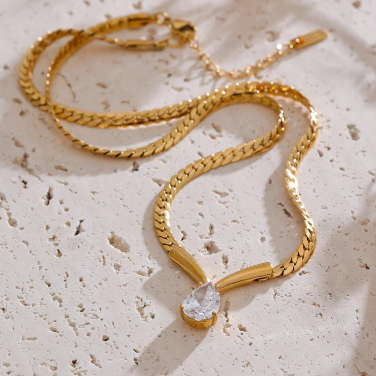 Whitney Necklace – sleek herringbone chain with a pear zircon pendant. Tarnish-free stainless steel, silver or gold. Adjustable fit.