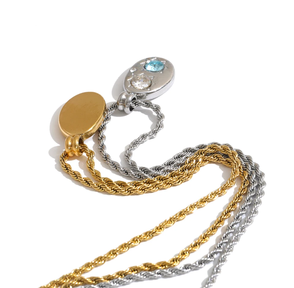 Shop the Alba Necklace: celestial-inspired oval pendant with aqua blue zircon. Waterproof stainless steel, silver or 18k gold-tone.