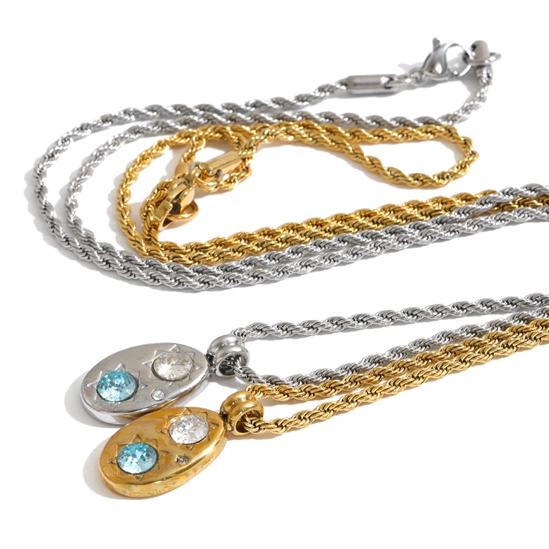 Shop the Alba Necklace: celestial-inspired oval pendant with aqua blue zircon. Waterproof stainless steel, silver or 18k gold-tone.