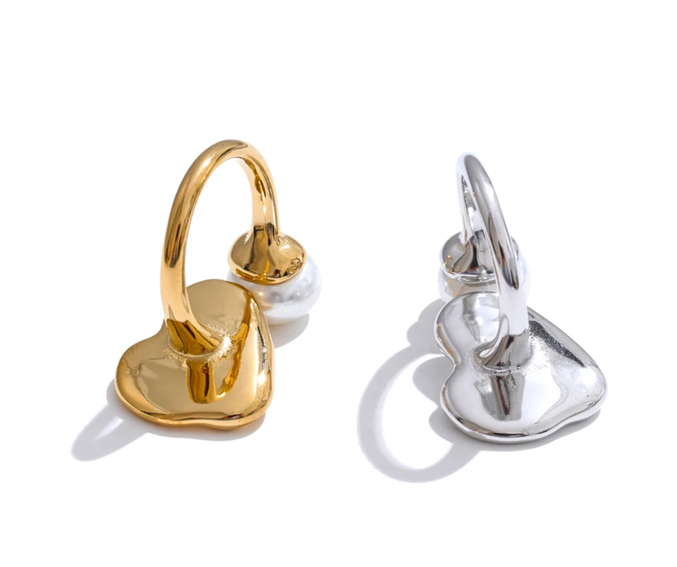 Gold and silver heart-shaped earrings on a white background