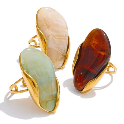 Three stone rings with gold bands on a white background,stainless steel waterproof