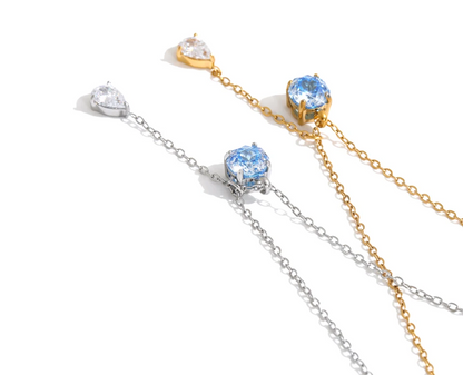 The Astrid Necklace: a blue zircon, a falling teardrop, a fine chain. Silver or gold. Tarnish-free, delicate.