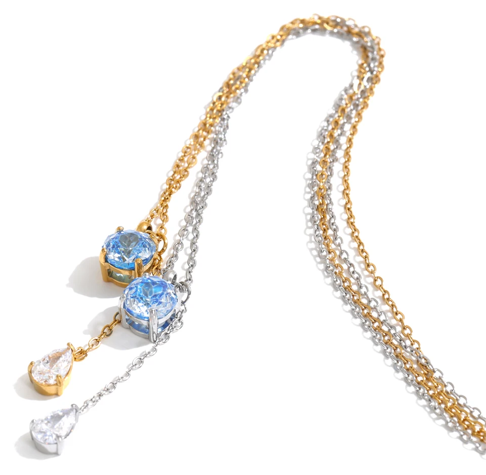 Shop the Astrid Necklace: delicate lariat with blue and clear zircons. Waterproof, hypoallergenic stainless steel in silver or 18k gold.
