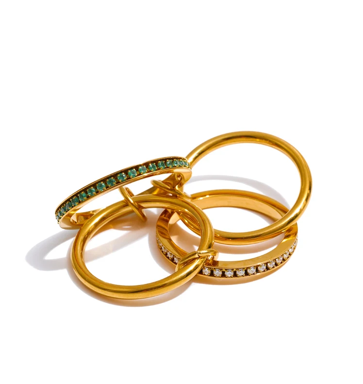 Three gold rings with gemstone accents on a white background