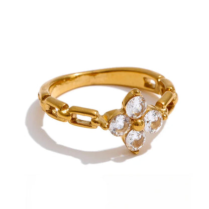 Gold ring with cubic zirconium accents on a white background